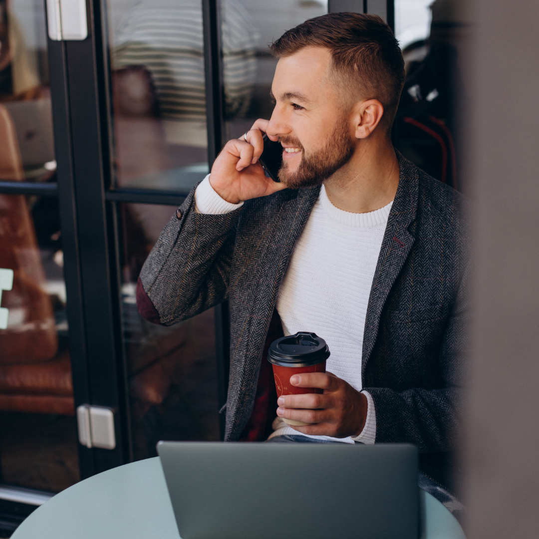 Young businessman during a phone call to discuss the options for in-company Dutch lessons.